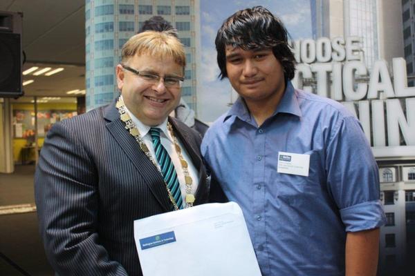Mayor Ray Wallace presents the Hutt City Centennial Scholarship to assist Junior Preston with his studies at Weltec.
